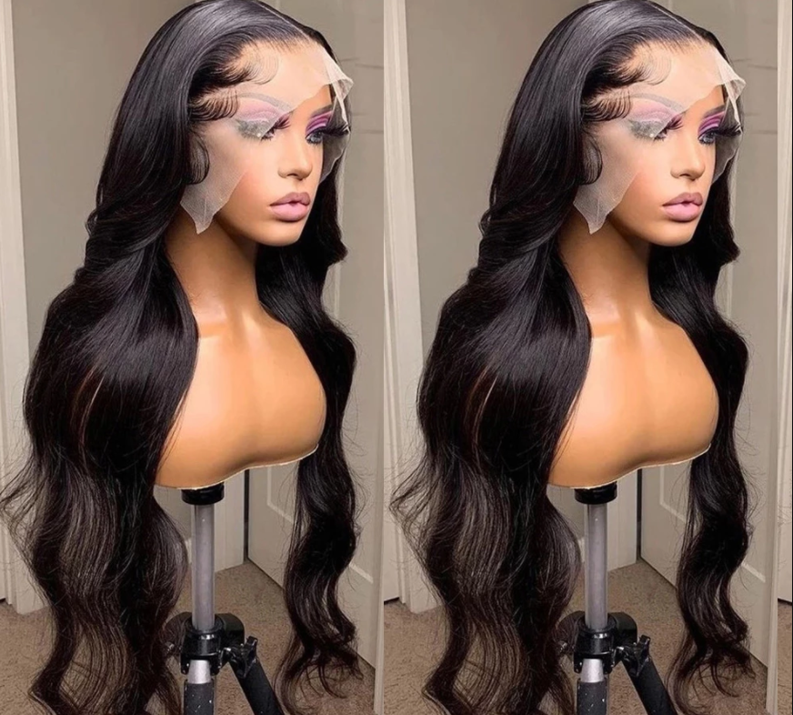 Model wearing a body wave human hair wig on a warm beige studio background