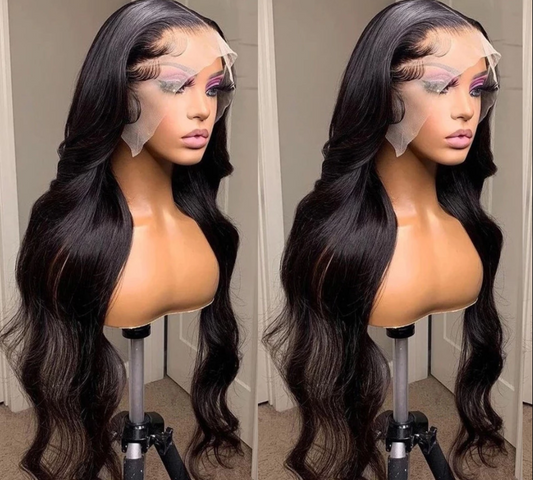 Model wearing a body wave human hair wig on a warm beige studio background
