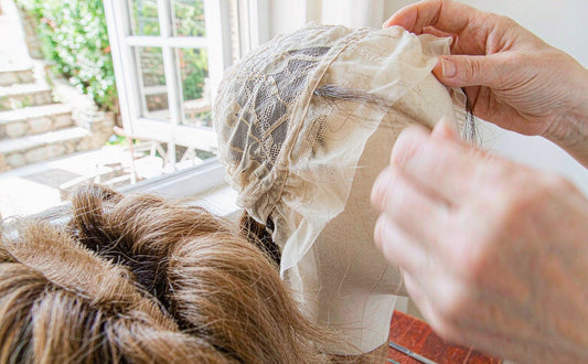 Hand-tying lace in our workshop